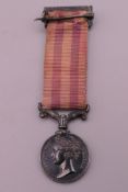 A silver miniature Indian mutiny medal, 1857-1859, with ribbon and pin.
