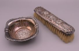 An 800 silver dish and a silver backed brush. Dish 10.5 cm wide, brush 17 cm long. The former 41.