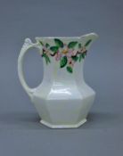 A Maling iridescent jug painted with blossoms. 19 cm high.