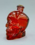 A red skull decanter. 16 cm high.