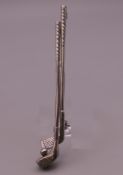 A silver bar brooch formed as golf clubs. 6.5 cm long.
