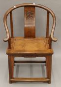 A Chinese carved elm open arm chair. 64 cm wide.