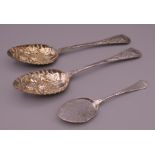 A silver jam spoon (23.3 grammes) and two plated spoons.