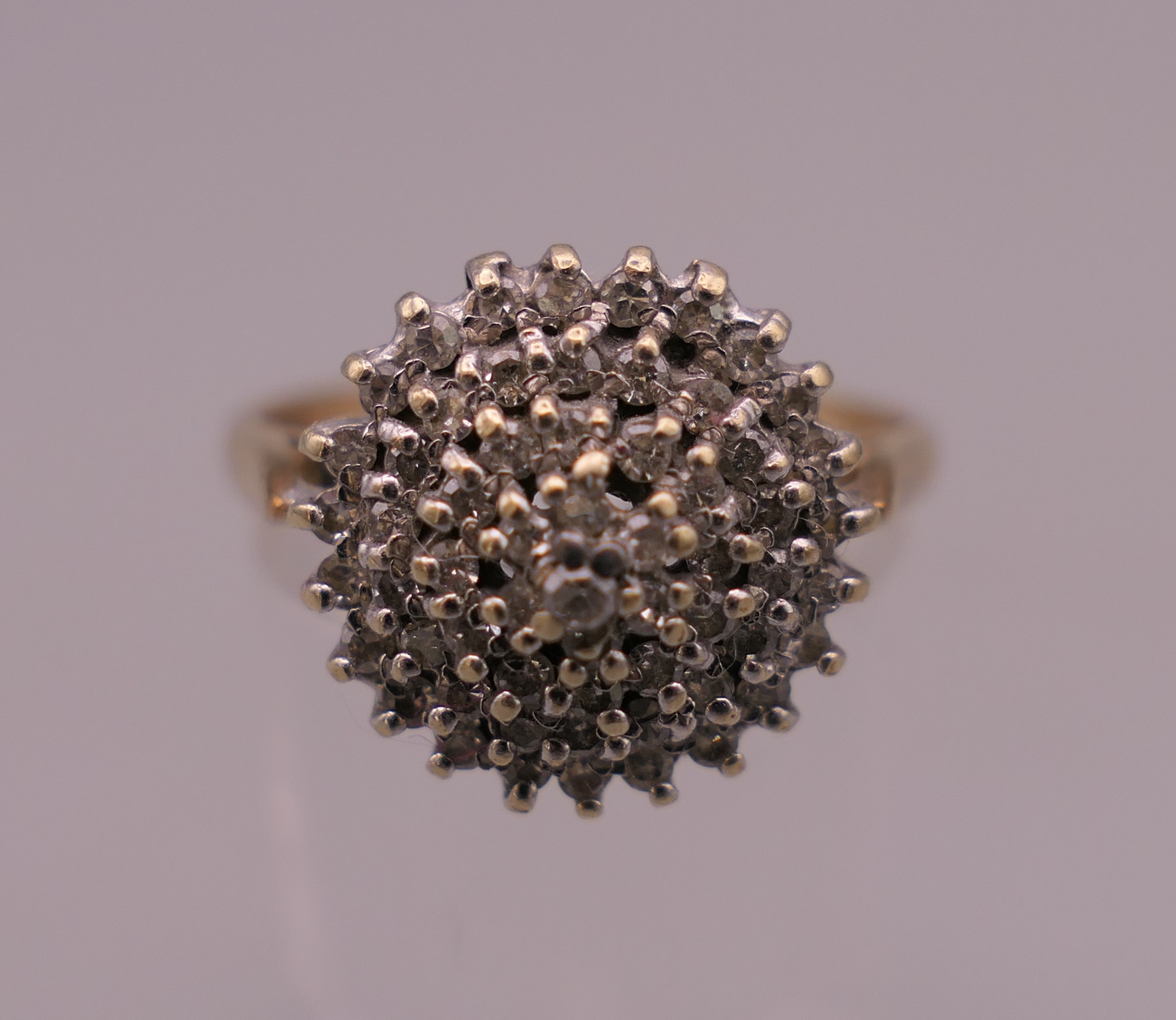 A 9 ct gold 0.5 carat diamond cluster ring. Ring size S/T. 4 grammes total weight.