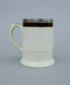 A 19th century Earthenware mug with Old Sheffield plate rim. 15.5 cm high.