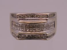 A 14 K white gold diamond ring. Ring size N/O. 8.5 grammes total weight.
