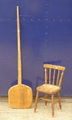 An elm seated child's stick back chair and a vintage bakers paddle. The latter 155 cm long.