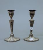A pair of silver candlesticks. 21 cm high.