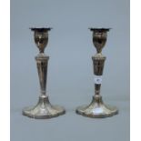 A pair of silver candlesticks. 21 cm high.