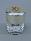 A silver dressing table pot, with unmarked gold lettering, hallmarked for London 1887,
