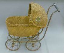 A Victorian wicker dolls pram. 73 cm long.