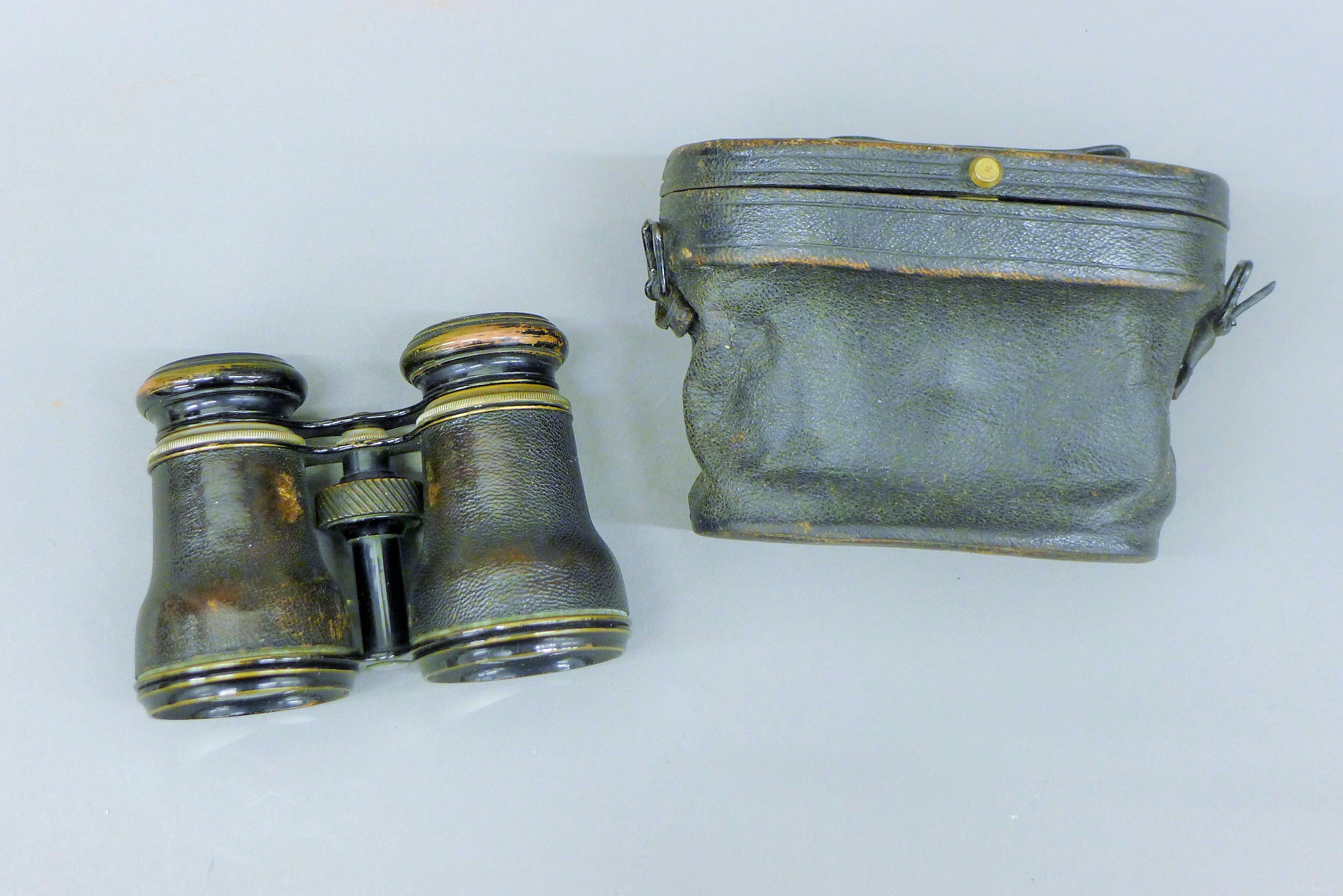 A pair of field glasses with inset compass, case. 13.5 cm wide overall.