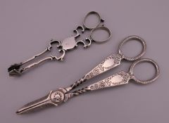 A pair of Georgian silver sugar nips and a pair of Edwardian silver grape scissors by Atkin