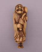 A 19th century carved bone netsuke formed as Sennin carrying a gourd. 7 cm high.