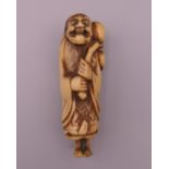 A 19th century carved bone netsuke formed as Sennin carrying a gourd. 7 cm high.