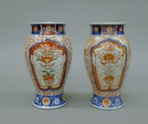 A pair of Imari vases painted with birds and flowers. 24 cm high.