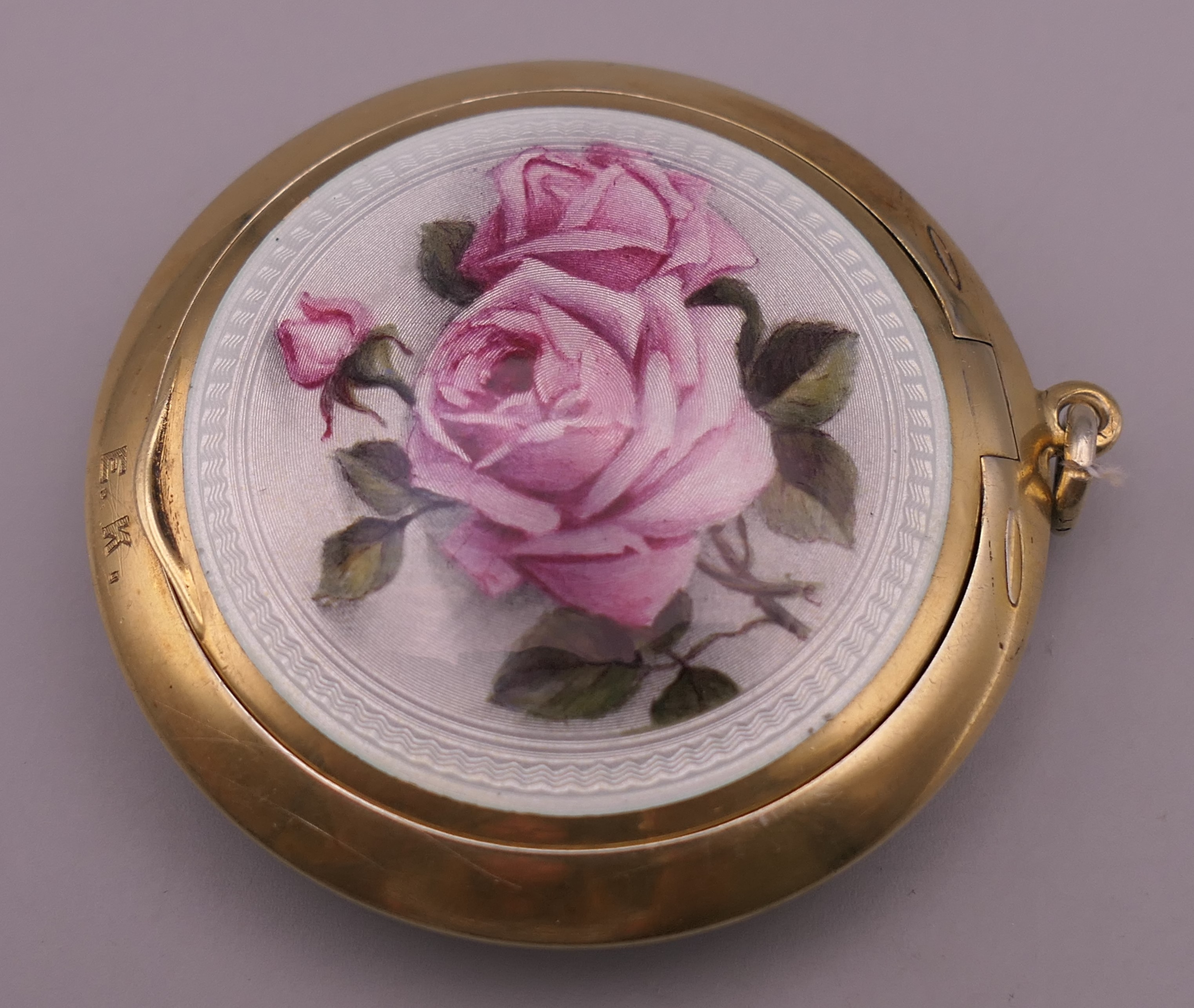A 925 silver gilt and enamel decorated compact. 5.5 cm diameter.
