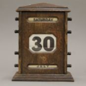 An early 20th century oak desk calendar. 25.5 cm high.