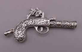 A silver gun form whistle. 7 cm long overall.