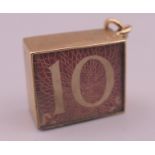 A 9 ct gold emergency ten shilling note charm. 1.5 cm long. 2.6 grammes total weight.