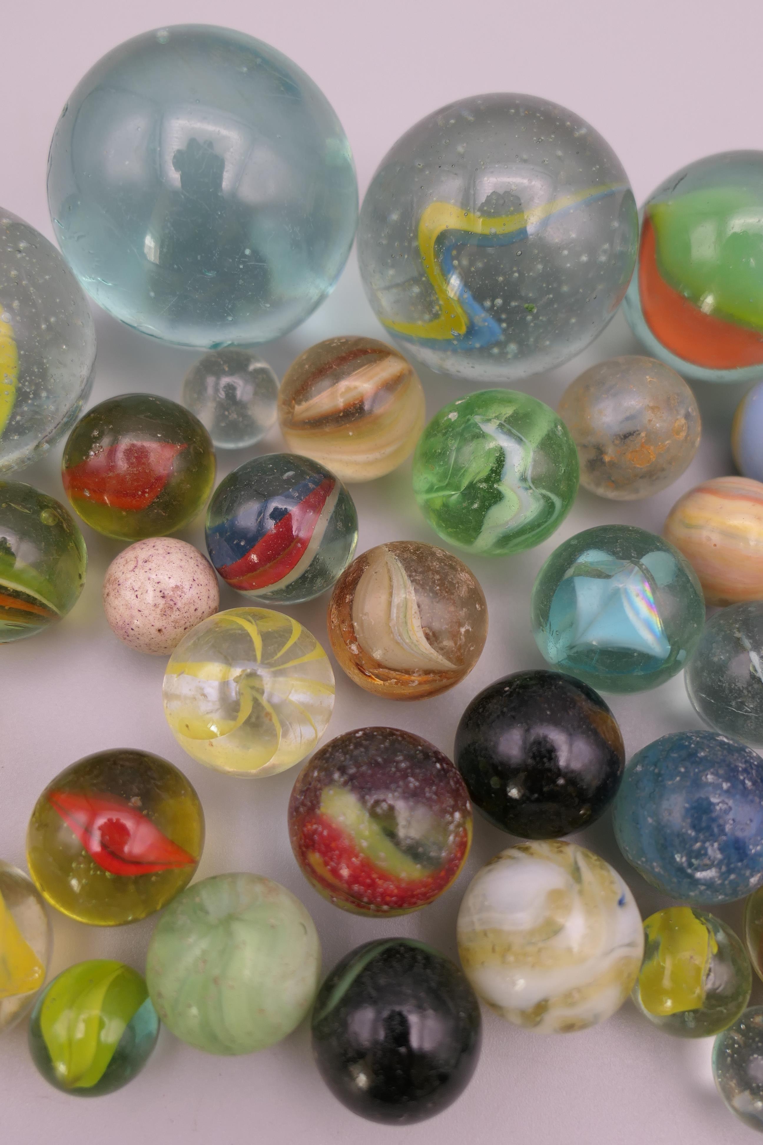 Four antique glass marbles (three approximately 1 inch diameter and the other 15/16th of an inch - Image 3 of 14