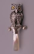 A sterling silver rattle formed as an owl. 8.5 cm high.