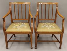 A pair of 19th century mahogany open arm chairs with tapestry seats. 59 cm wide.