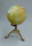 A late 19th/early 20th century globe. 37 cm high.