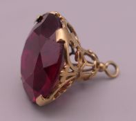 A 9 ct gold red stone fob. 2.5 cm high. 7 grammes total weight.