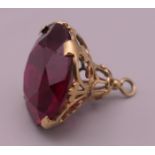 A 9 ct gold red stone fob. 2.5 cm high. 7 grammes total weight.