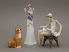 A Lladro ballerina, a Lladro bell and a Doulton cat. The bell 19 cm high.