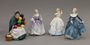 Four Royal Doulton porcelain figurines.