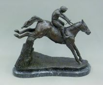 A bronze model of a horse with jockey up. 32.5 cm high.