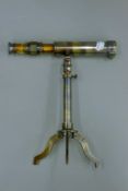 A telescope on stand. 23.5 cm long.