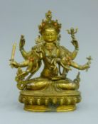 A gilt bronze model of Buddha decorated with coral and turquoise. 21.5 cm high.