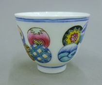 A Chinese porcelain tea bowl decorated with circles. 7.5 cm diameter.