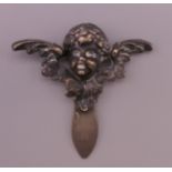 A silver bookmark formed as a cherub's head and wings. 5 cm x 5 cm.