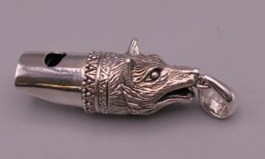 A silver whistle formed as a fox mask. 4.5 cm high overall.