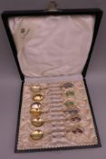 A set of six plique-a-jour decorated 925 silver gilt spoons. Each approximately 9.5 cm long.