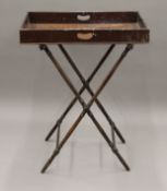 A Victorian mahogany butlers tray on stand. 74.5 cm long.