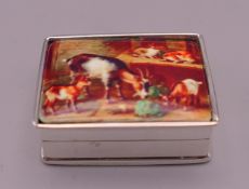 A silver pill box depicting a farm yard scene. 3 cm wide.
