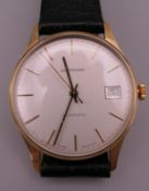 A Garrard 9 ct gold gentleman's wristwatch. 3.5 cm wide.
