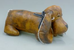 Two leather doorstops formed as dogs. The largest 32 cm high.