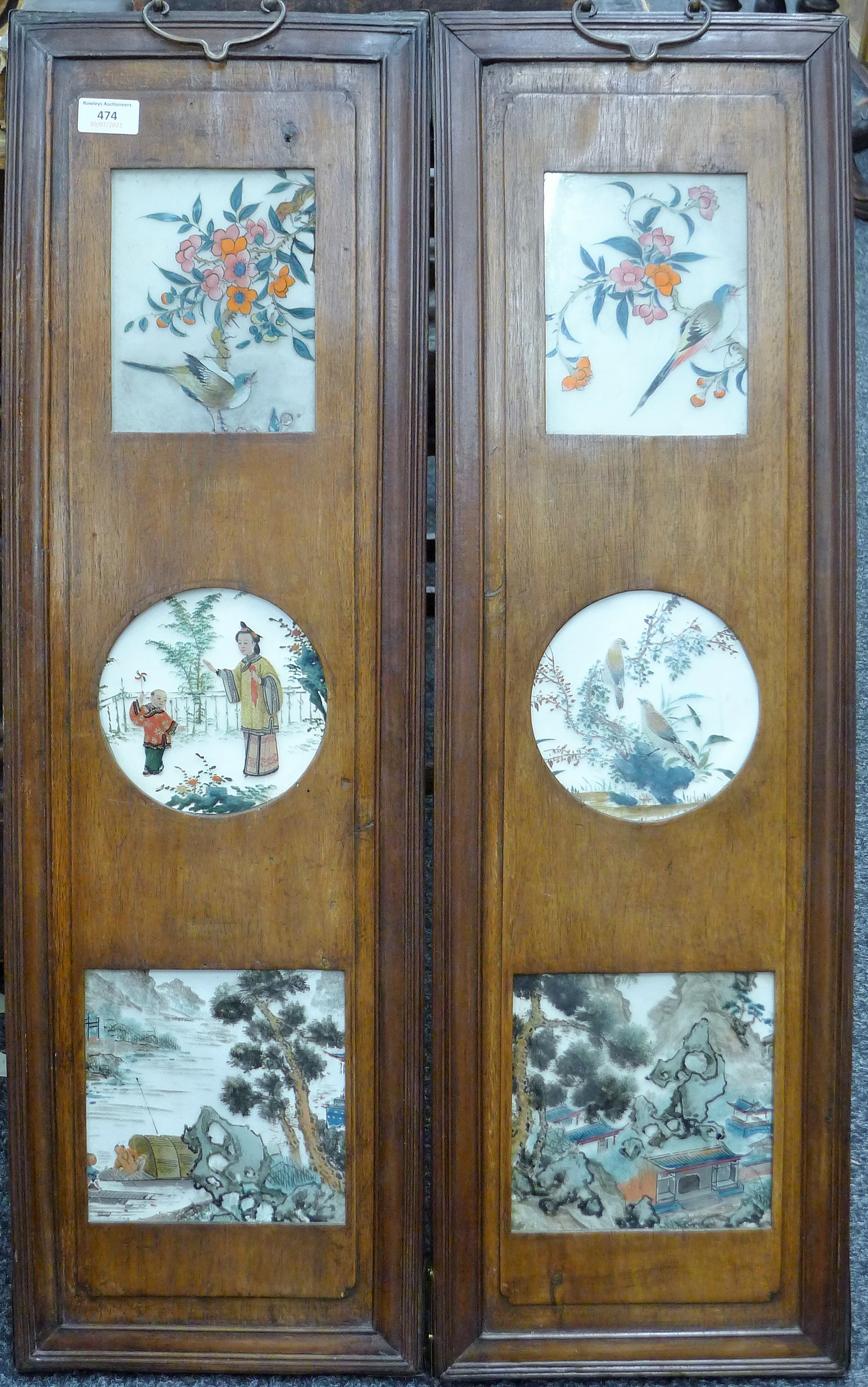 A pair of Chinese hardwood and reverse painted glass panels. Each 26.5 x 88 cm.