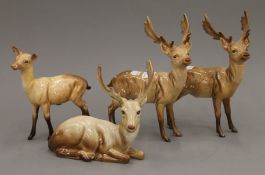 Four Beswick porcelain models of deer. The largest 19.5 cm high.