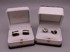 Two pairs of boxed cufflinks.