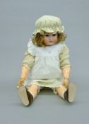 A late 19th/early 20th century bisque headed doll by Simon and Halbig. 70 cm tall.