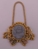 An antique yellow metal lava cameo pendant. 4.5 cm wide. 7.7 grammes total weight.