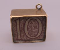 A 9 ct gold emergency ten shilling note charm. 1.4 cm long. 2.5 grammes total weight.