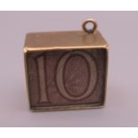 A 9 ct gold emergency ten shilling note charm. 1.4 cm long. 2.5 grammes total weight.